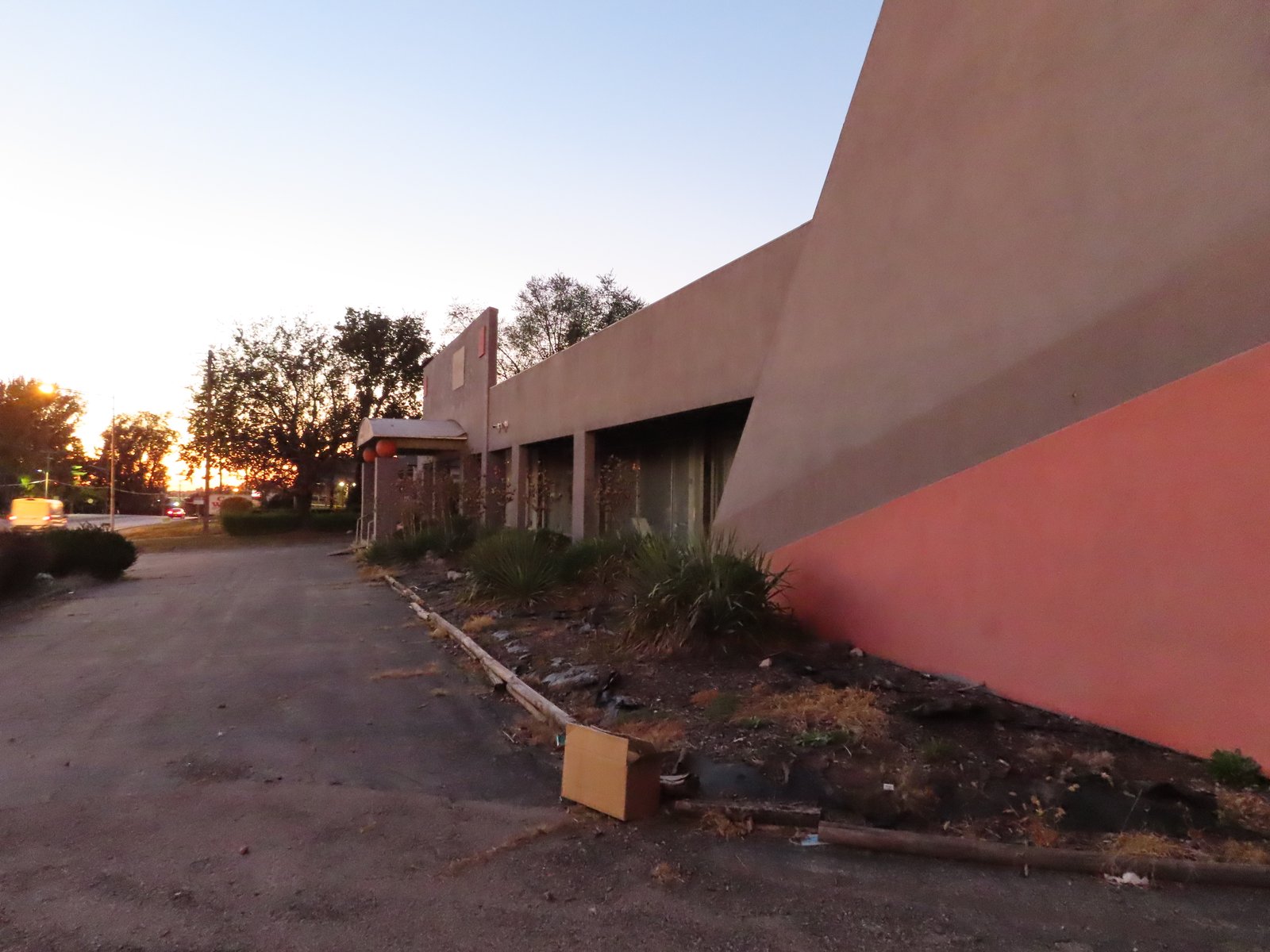 Long view of the front of the building taken from the corner showing traffic lights in the background.