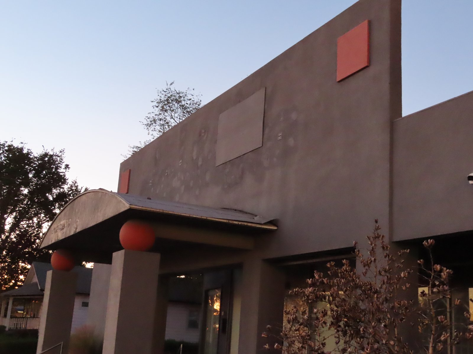 Front of commercial building with gray paint and pink color blocks.