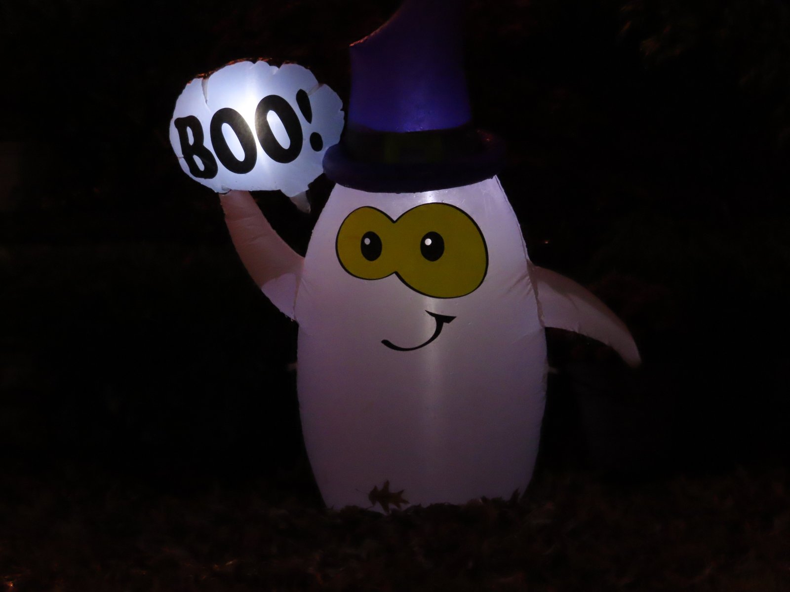 A blowup ghost in a hat saying Boo!